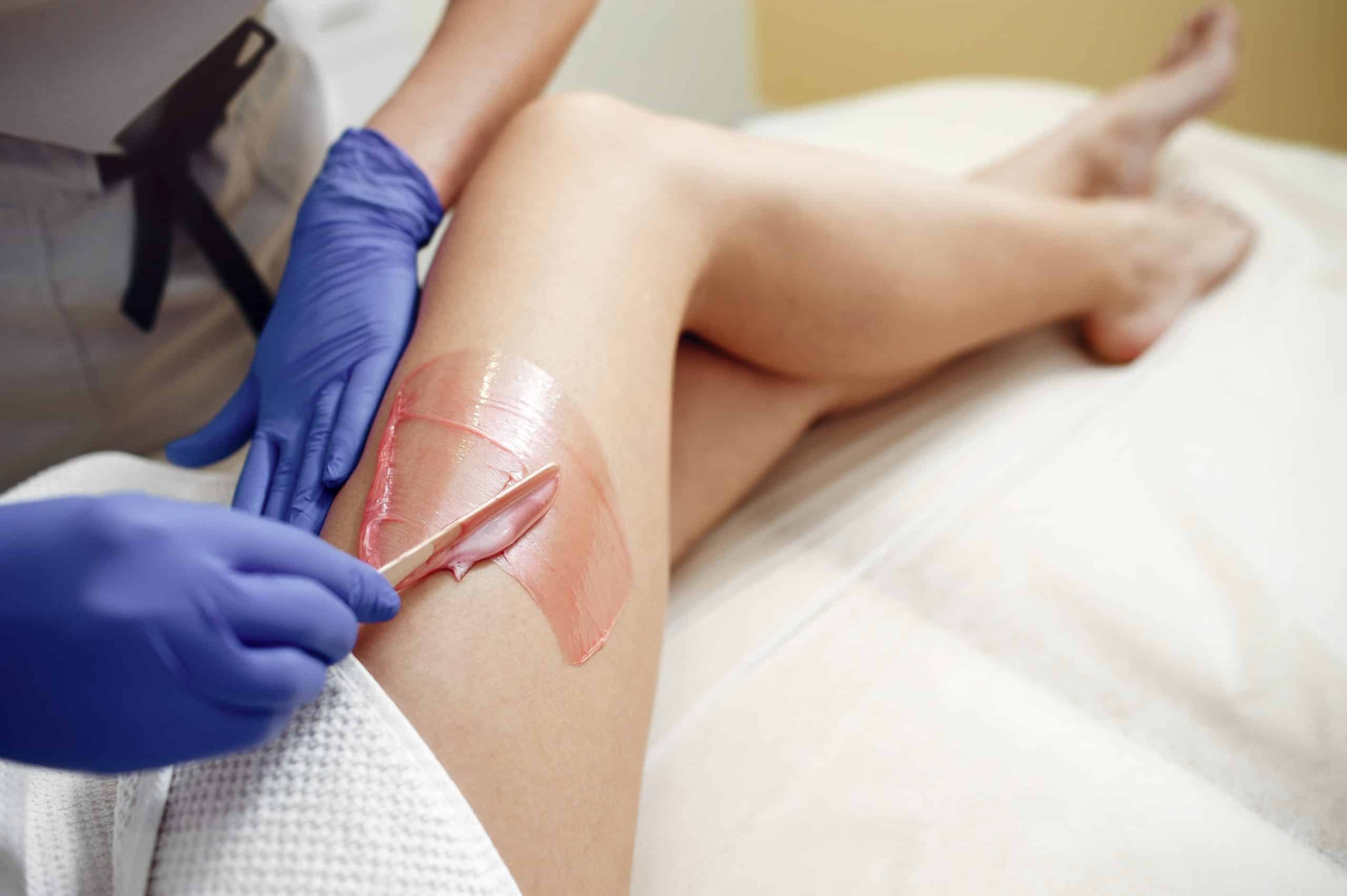 Girl getting Hair Removal by waxing creams