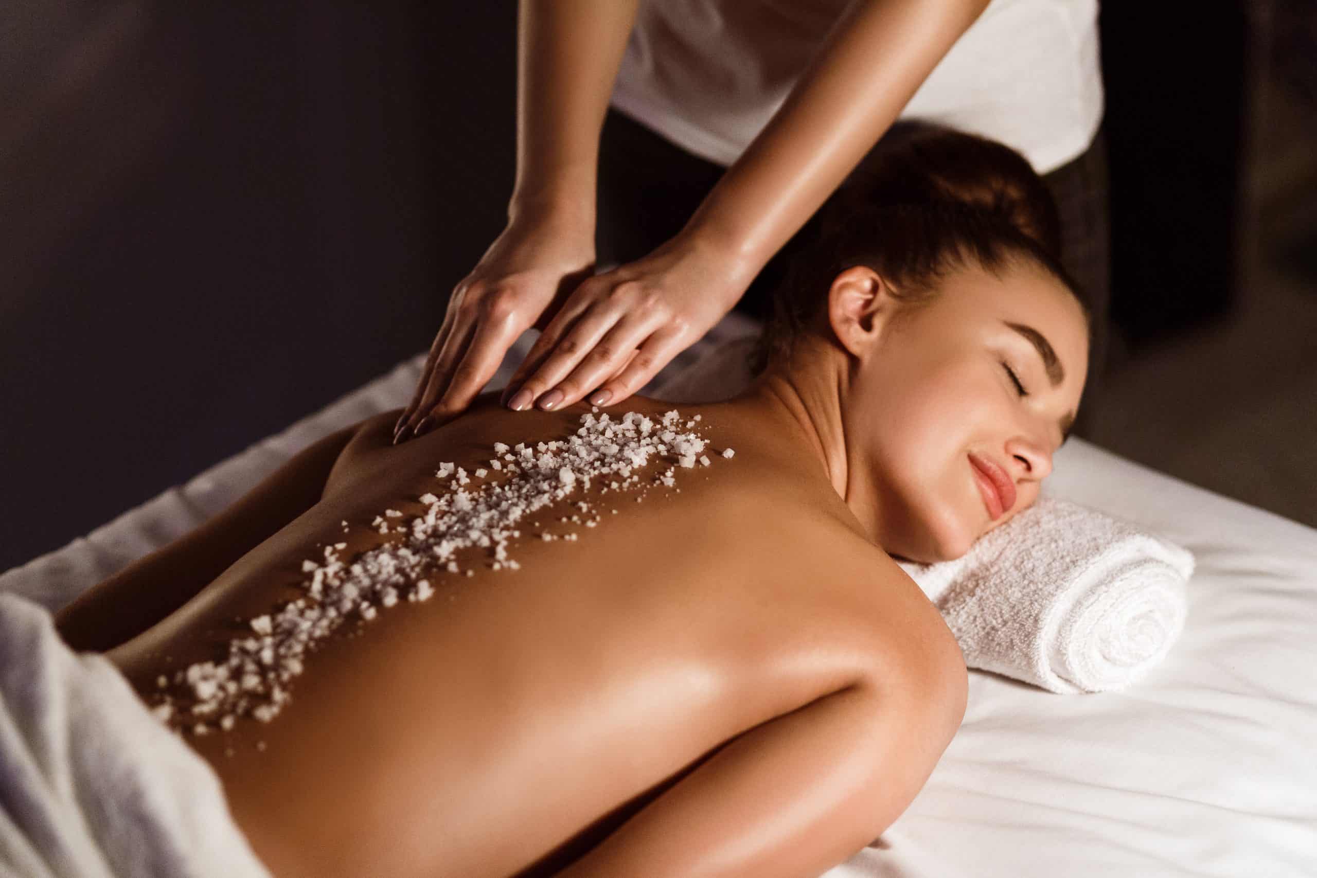 Woman Enjoying Salt Scrub Massage, Relaxing In Health Spa
