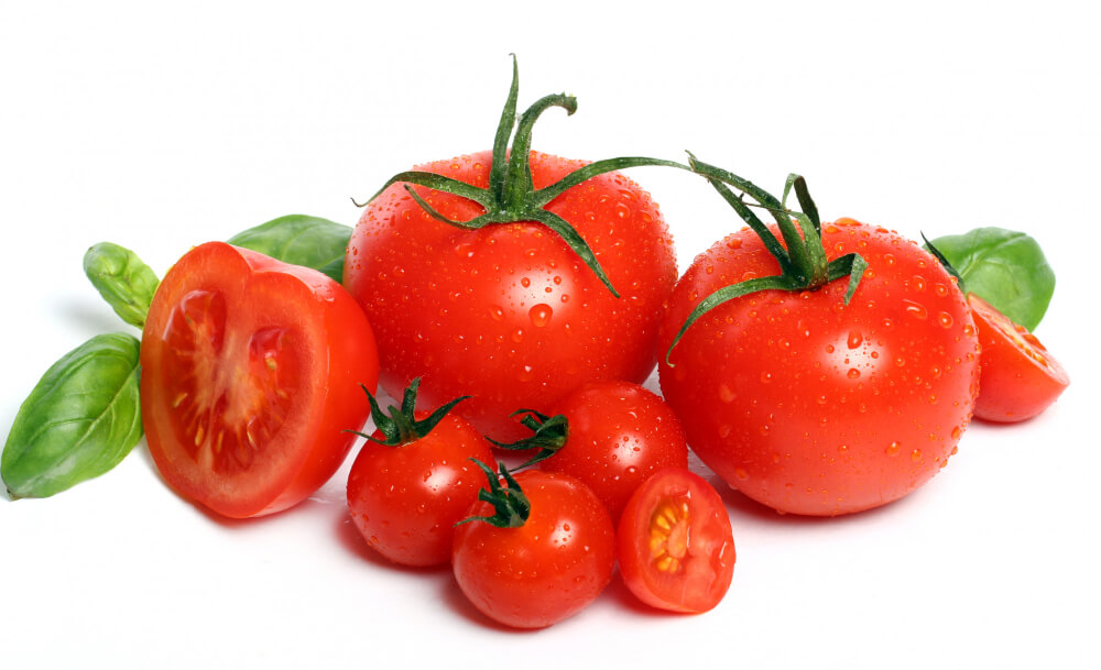 Fresh tomatoes rich in antioxidants like lycopene, known to naturally brighten skin and reduce pigmentation. 