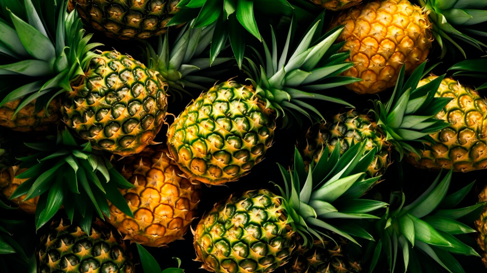 Whole pineapples rich in vitamin C and bromelain, helping to naturally brighten skin and enhance your complexion. 